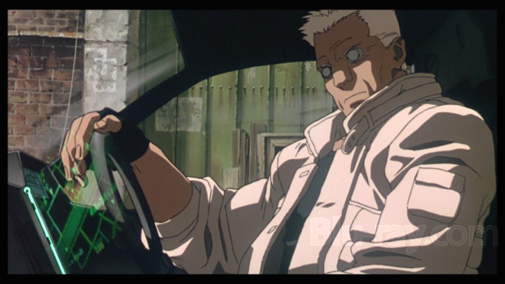 Film frame: Batou driving, cybernetic eyes glowing